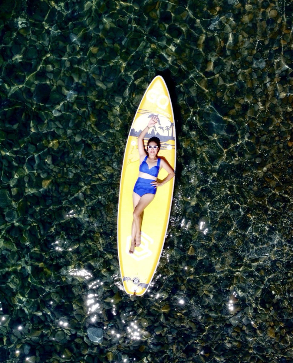 Drone view — paddleboarding on crystal clear waters